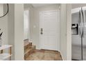 Entryway featuring tile flooring, stainless steel fridge, and access to other rooms at 10324 Lettuce Leaf St, Las Vegas, NV 89183