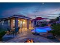 Inviting backyard with a sparkling pool, patio, and a cozy fire pit area, perfect for outdoor relaxation and entertaining at 10385 Kern Ridge St, Las Vegas, NV 89178