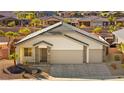Inviting single-story home featuring a two-car garage and well-maintained desert landscaping at 1357 Manassas Rdg Rdg, Mesquite, NV 89027