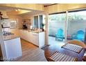 Bright kitchen featuring white cabinets, granite countertops, and access to outdoor patio at 1370 Vegas Valley Dr # 47, Las Vegas, NV 89169