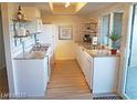 Bright kitchen featuring white cabinets, granite countertops, and modern appliances at 1370 Vegas Valley Dr # 47, Las Vegas, NV 89169