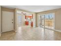A tiled living room opens into the kitchen, complemented by a ceiling fan and a sliding door to the patio at 1405 Vegas Valley Dr # 257, Las Vegas, NV 89169