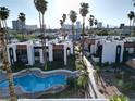 Above angle view of the community pool and the apartment buildings with palm trees and city views at 1405 Vegas Valley Dr # 257, Las Vegas, NV 89169