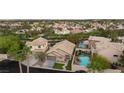 The aerial view showcases a home with a pool and spa in a lush neighborhood setting at 19 Dryden Park Ave, Las Vegas, NV 89148