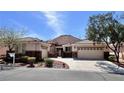 Charming single-story home with a tile roof, desert landscaping, and a spacious three-car garage at 1963 Dakota Lodge Ave, Las Vegas, NV 89123