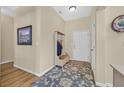 Welcoming entryway with wood floors, coat rack, decorative rug and adjacent hallway at 1991 High Mesa Dr, Henderson, NV 89012