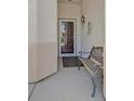 Inviting front porch area with a bench, decorative light fixture, and security screen door at 1991 High Mesa Dr, Henderson, NV 89012