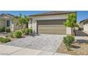 Single-story home with a desert landscape and paver driveway at 2110 Albury Ave, North Las Vegas, NV 89086