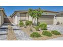 Single-story home featuring desert landscaping, pavers, and a two-car garage at 2110 Albury Ave, North Las Vegas, NV 89086
