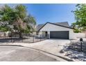 Charming single-story home featuring a gated front yard, desert landscaping and a spacious driveway leading to a two-car garage at 2671 Diamante Cir, Las Vegas, NV 89121