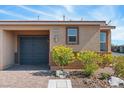 Attractive home with a two-car garage, desert landscaping, and a cozy front porch at 2685 Crystal Blue St, Laughlin, NV 89029