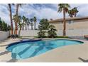 The serene backyard boasts a refreshing pool, spa, and lush landscaping for ultimate relaxation at 3005 Stern Dr, Las Vegas, NV 89117