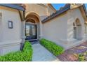 Stunning home featuring arched entryway with ornate double doors and manicured landscaping at 3091 Via Del Corso, Henderson, NV 89052