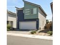 Two-story home with two-car garage, modern window design, and low-maintenance landscaping at 3767 Paseo De Paz Ave, Las Vegas, NV 89115