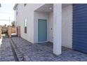 Charming covered entryway with modern door and gray brick pavers at 3767 Paseo De Paz Ave, Las Vegas, NV 89115