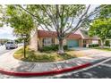 Charming single-story home featuring a red tile roof and lush landscaping in a tranquil neighborhood at 3879 Atlantis St, Las Vegas, NV 89121