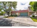 Charming single-story home featuring a red tile roof and lush landscaping in a tranquil neighborhood at 3879 Atlantis St, Las Vegas, NV 89121