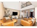Inviting living room featuring soaring ceilings, stylish furnishings, and abundant natural light at 3934 Sangre De Cristo Ave, Las Vegas, NV 89118