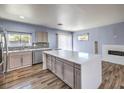 Bright kitchen featuring stainless steel appliances, stylish cabinetry, and a large island with a sleek countertop at 417 Wisteria Ave, Las Vegas, NV 89107