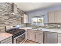 Updated kitchen with stainless steel appliances and gray backsplash at 417 Wisteria Ave, Las Vegas, NV 89107