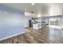 Open living area with wood flooring, stainless steel appliances, and natural light at 417 Wisteria Ave, Las Vegas, NV 89107