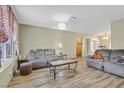 Comfortable living room features wood flooring, neutral walls and cozy seating at 421 Engel Ave, Henderson, NV 89011