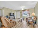 Cozy living room featuring wood flooring, comfortable seating and natural light from a window at 421 Engel Ave, Henderson, NV 89011