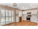 Modern kitchen featuring stainless appliances, tile floors, and sliding door access to the outside at 4411 Wild Honey Ct, Las Vegas, NV 89147