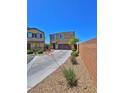 Front exterior view of home with desert landscaping, driveway, and brick perimeter wall at 4905 Quiet Morning St, Las Vegas, NV 89122