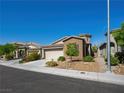 View of a single-Gathering home with a beige garage door, neutral paint, and lovely landscaping at 5521 Moss Landing St, North Las Vegas, NV 89031
