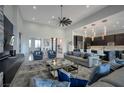 Inviting open-concept living room features comfortable seating and seamless connection to the modern kitchen at 600 Quail Covey Road, Henderson, NV 89002
