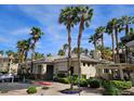 Community clubhouse with manicured landscaping and ample parking at 7115 S Durango Dr # 208, Las Vegas, NV 89113