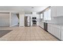 Bright kitchen with white cabinets, stainless steel appliances, and tiled flooring at 7857 Midnight Ride St, Las Vegas, NV 89131