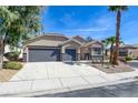 Inviting single-story home with a three-car garage, desert landscaping, and a neatly paved driveway at 8080 Black Orchid Ave, Las Vegas, NV 89131