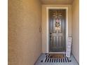 Inviting front entry features a decorative wreath, cute welcome mat, and charming 'howdy' sign to greet guests at 813 Bluebird Hill Ave, North Las Vegas, NV 89084