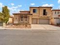 Beautiful two-story home featuring a tandem garage and stone accents at 8267 Campbell Springs Ave, Las Vegas, NV 89178
