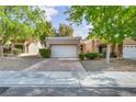 Charming single-story home with a two-car garage, mature trees, and low-maintenance landscaping at 8904 Evening Star Dr, Las Vegas, NV 89134
