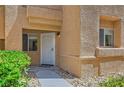 Charming condo entrance with a well-lit walkway leading to the front door at 900 Heavenly Hills Ct # 112, Las Vegas, NV 89145
