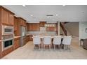 Beautiful kitchen with stainless steel appliances, center island and breakfast bar seating at 917 Pomander Point Pl, Henderson, NV 89012