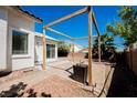 Private backyard featuring a stone patio and wooden pergola, perfect for outdoor living at 10404 Shadowland Ave, Las Vegas, NV 89144