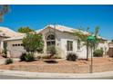 Close-up of a well-maintained single-story home with desert landscaping and a tile roof at 10404 Shadowland Ave, Las Vegas, NV 89144