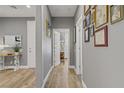 Inviting hallway featuring hardwood floors and decorative wall art at 11249 Revelry Ln, Las Vegas, NV 89138
