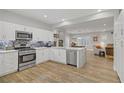 Spacious kitchen with stainless steel appliances and a view into the open-plan living area at 11249 Revelry Ln, Las Vegas, NV 89138
