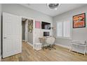Bright office space with hardwood floors, shuttered window, and modern desk setup at 11249 Revelry Ln, Las Vegas, NV 89138