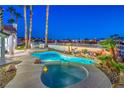Backyard oasis includes a gorgeous pool, spa, and lush landscaping, ideal for relaxation at 1144 Calico Ridge Dr, Henderson, NV 89011