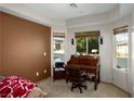 Inviting home office with a classic wooden desk and ample natural light from the windows at 1153 Mesa Verde Run, Mesquite, NV 89027