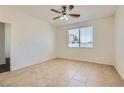 Bright and airy bedroom with a ceiling fan and tile flooring, offering a serene retreat at 1197 Bear Head St, Henderson, NV 89011