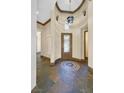 Elegant foyer featuring slate floors, mosaic accents, an ornate door, and decorative lighting fixtures above at 12 Via Ravello, Henderson, NV 89011