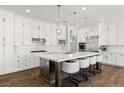 Modern kitchen features white cabinets, stainless steel appliances, a large island, and stylish pendant lighting at 12024 Girasole Ave, Las Vegas, NV 89138