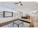 Spacious living room with a custom built-in unit, hardwood floors, and large windows for ample natural light at 12024 Girasole Ave, Las Vegas, NV 89138